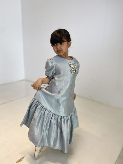 صورة فستان ازرق فاتح مع فينكة الؤلؤ على الصدر الانيقه